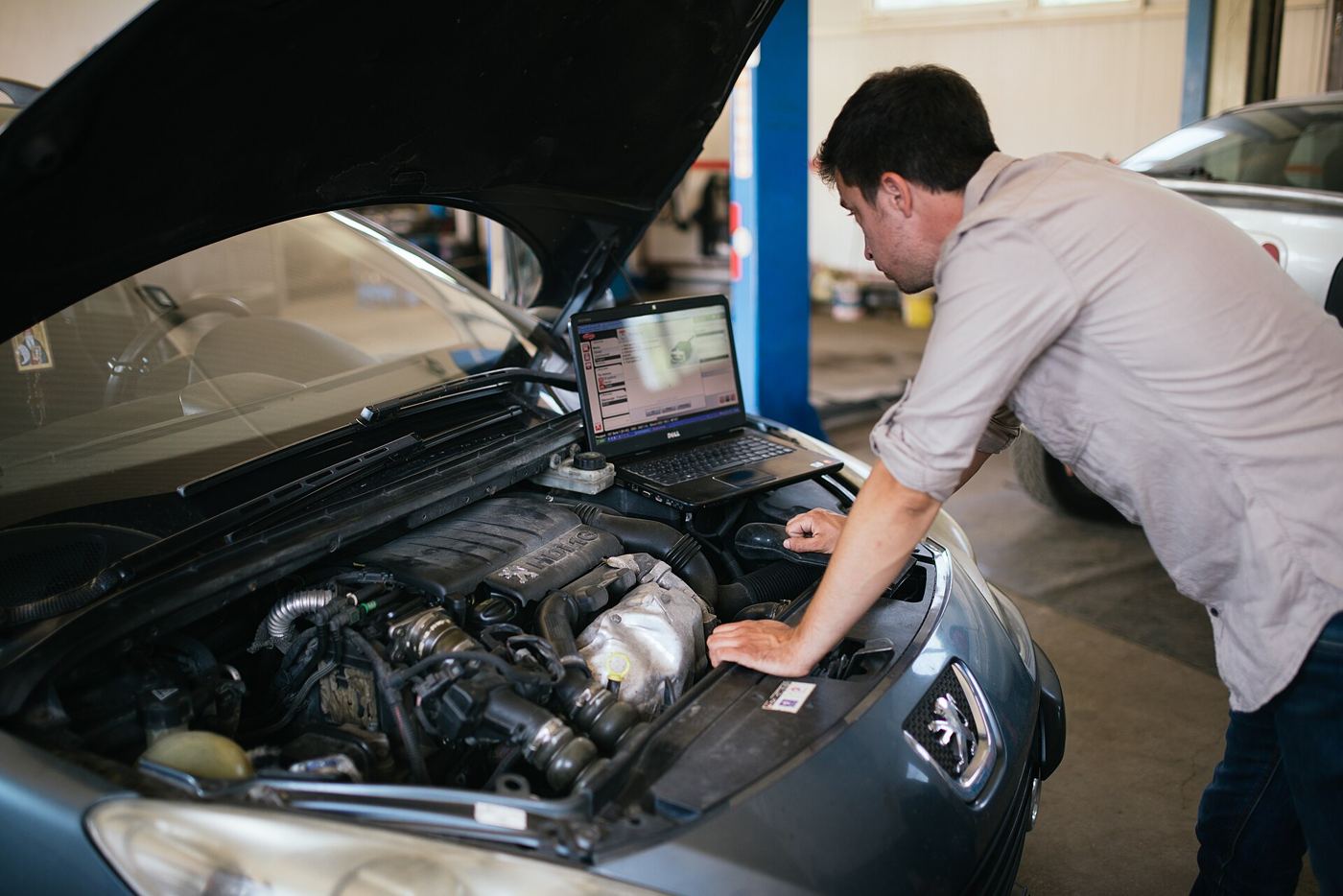 A laptop being repaired on a workbench